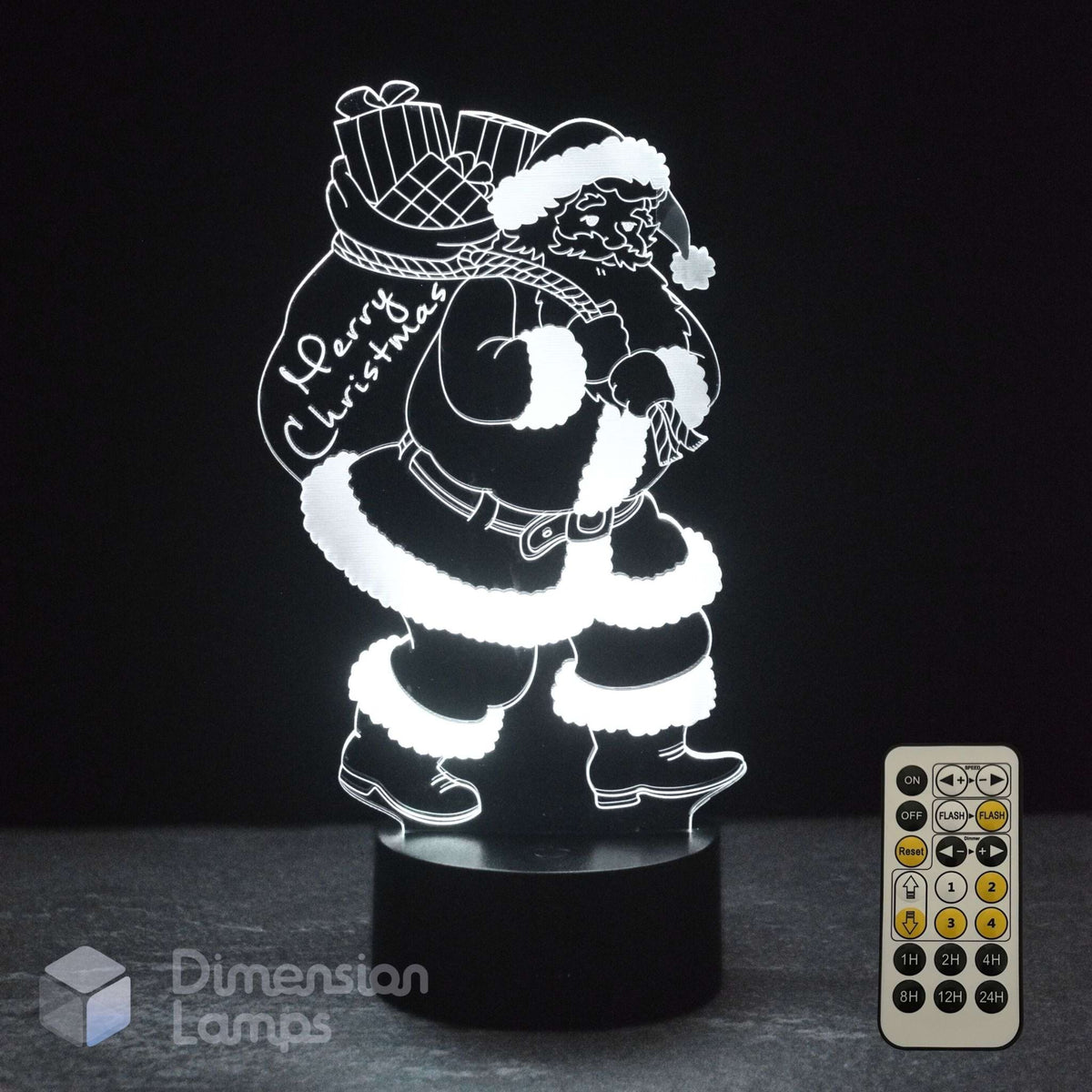 A glowing white Santa Claus 3D LED night light carrying a Christmas sack with 'Merry Christmas' written on it, on a black base with a remote control.