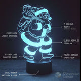 A 3D LED acrylic lamp of Santa Claus carrying a Christmas sack, glowing white against a dark background. Featuring text callouts pointing to features.