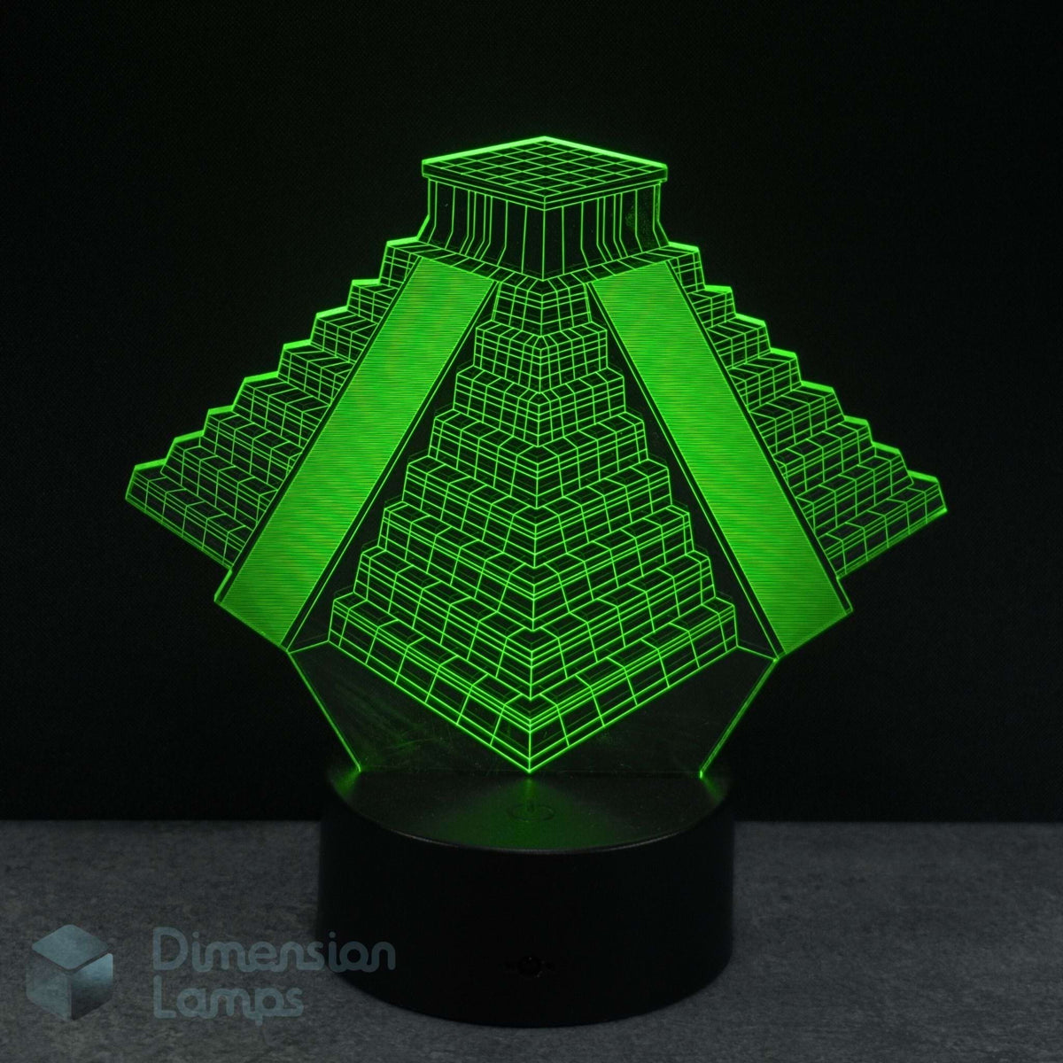 3D pyramid-shaped lamp with green light on a black background. Ancient history biff gift idea. 