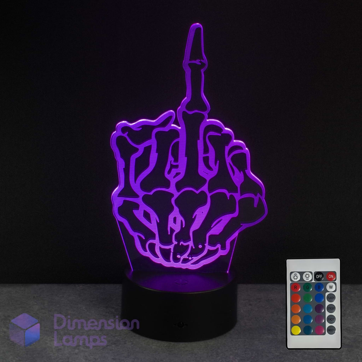 A purple 3D optical illusion night light shaped like a skeletal hand showing the middle finger, illuminated on a black base with a 16 colour remote control in the bottom right corner.