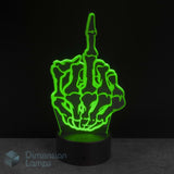 A 3D optical illusion LED night light shaped like a skeleton hand making the middle finger, glowing bright green on a black base against a dark background. Novelty young adult fun gift idea. 
