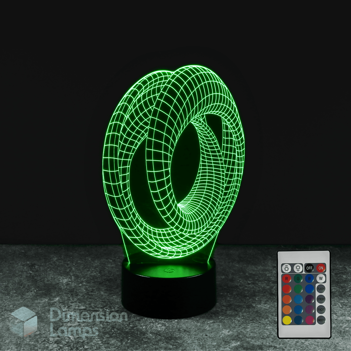 Green 3D lamp with remote control on a dark background