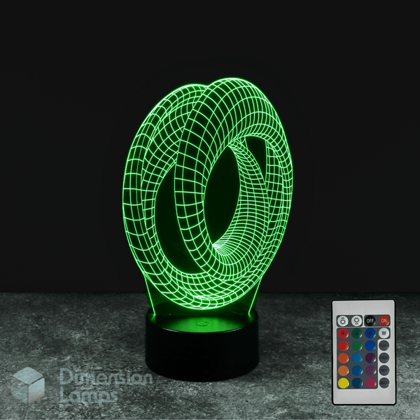 Green 3D lamp with remote control on a dark background