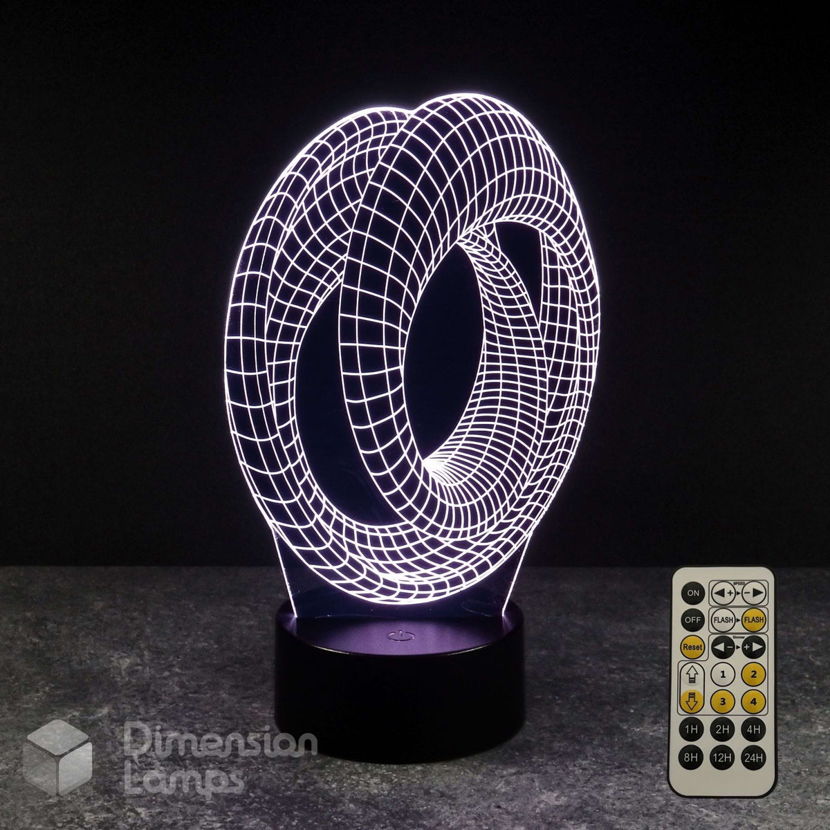 A 3D optical illusion LED night light with a glowing white wireframe mobius strip design on a black base, shown with its remote control on a dark grey surface against a black background. Sci-fi fan gift idea.