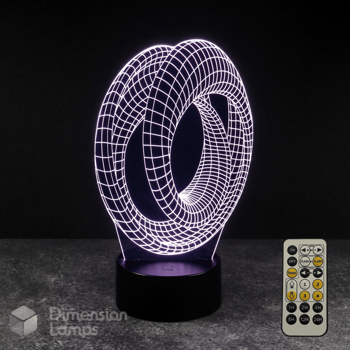3D optical illusion lamp with remote control on a dark surface