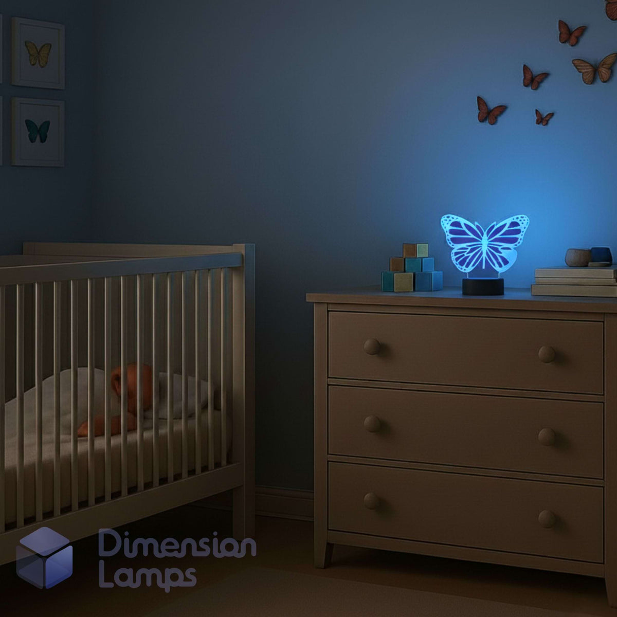 The Monarch Butterfly LED 3D lamp used as a night light in a child's bedroom, casting a soothing blue glow amongst butterfly wall decorations. Nursery gift idea.