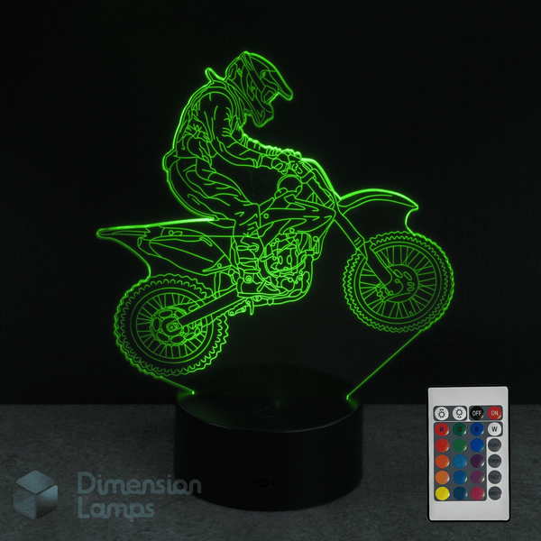 3D LED lamp with a motorcycle design and remote control on a dark background making it a perfect gift idea for dirt bike riders..