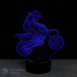 3D LED lamp of a motocross rider on a bike with blue light on a black Gift idea for dirt bike riders background.