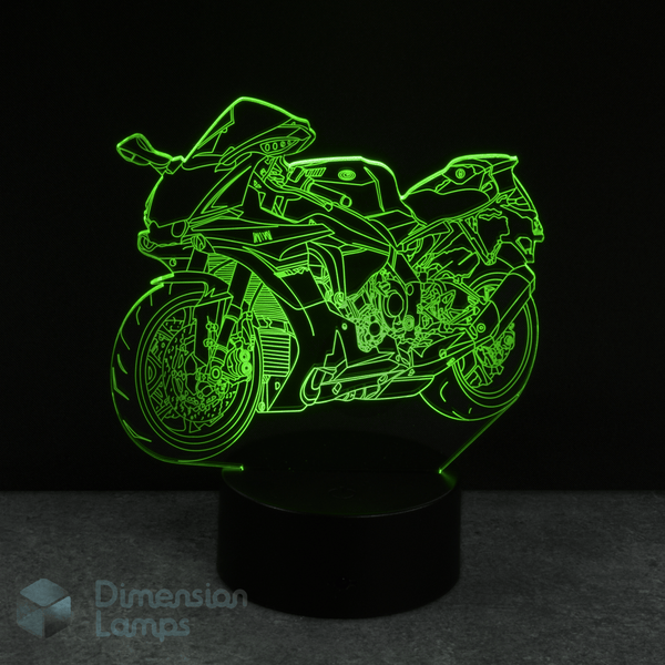 Motorcycle-shaped night light with green outline on a black background. Suitable as a gift idea for teenagers.