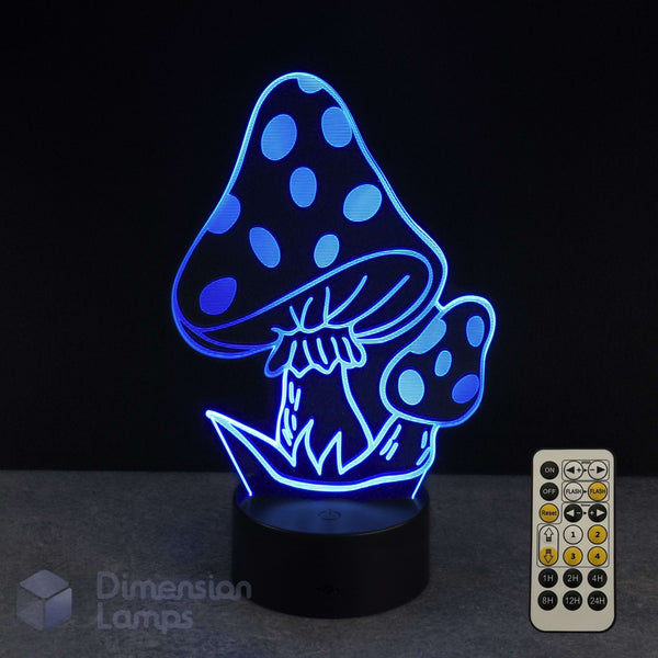 A 3D optical illusion night light shaped like mushrooms, glowing with blue LED light on a black base, shown with its remote control against a dark background. Fantasy gift idea.