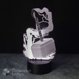 A 3D optical illusion LED night light depicting Thor holding his hammer Mjolnir, illuminated on a black circular base against a dark background. A watermark for 'Dimension Lamps' is visible in the bottom-left corner.