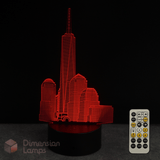 Red 3D One World Trade Center cityscape lamp with remote control on a dark background