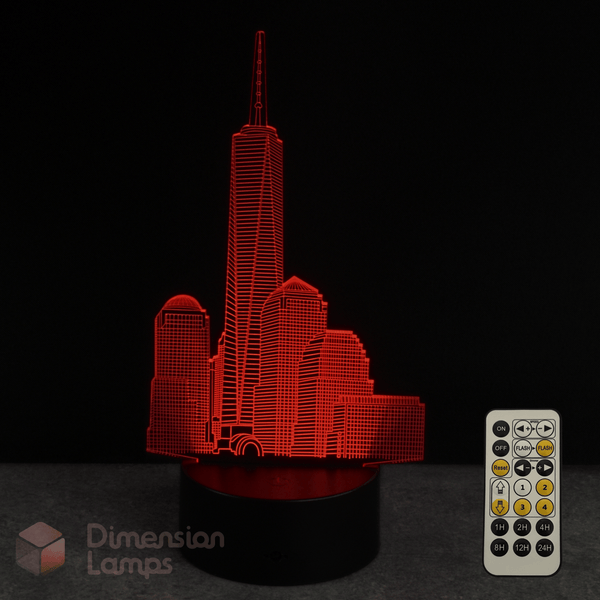 Red 3D One World Trade Center cityscape lamp with remote control on a dark background