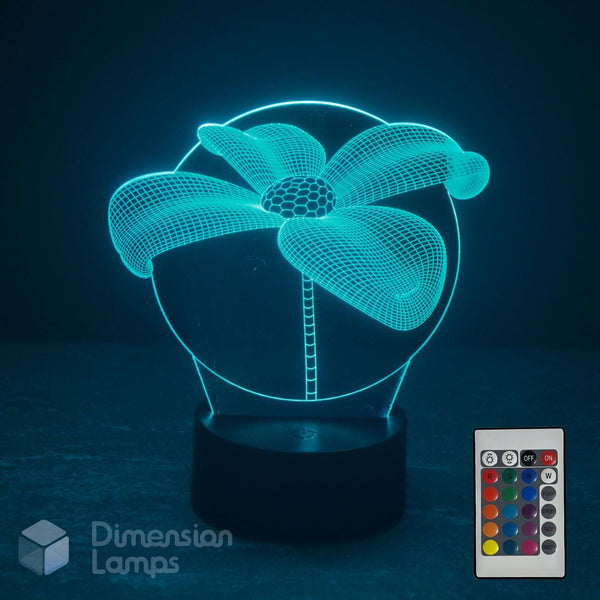 A 3D optical illusion LED night light shaped like a lily flower, glowing with a cyan light on a black base, shown with a remote control and the 'Dimension Lamps' logo on a dark background.