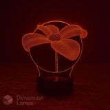 A 3D optical illusion LED lamp shaped like a flower, glowing with a warm red light on a dark base against a black background. A 'Dimension Lamps' watermark is visible in the lower-left corner.