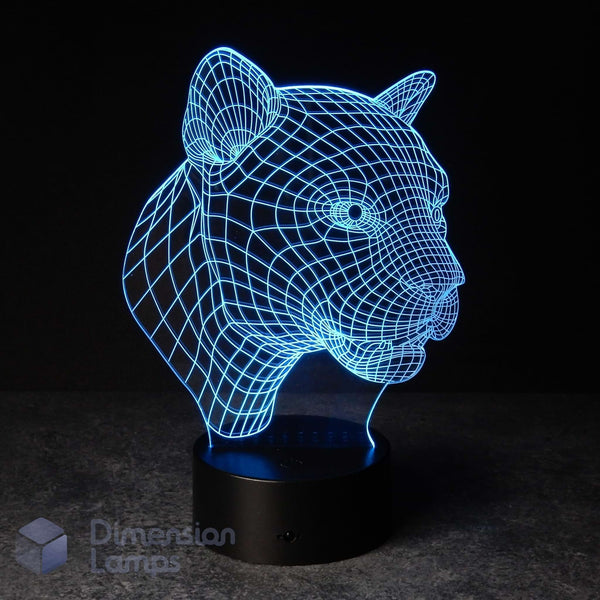 A 3D optical illusion LED lamp shaped like a panther head, glowing with a blue wireframe effect on a black base. The Aussie brand 'Dimension Lamps' is faintly visible in the bottom-left corner. Big cat gift idea. 