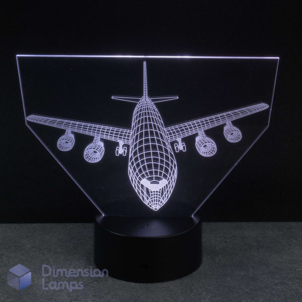 An LED acrylic 3D illusion lamp featuring a white wireframe airplane design on a black base, photographed against a dark background. Kids airplane gift idea.