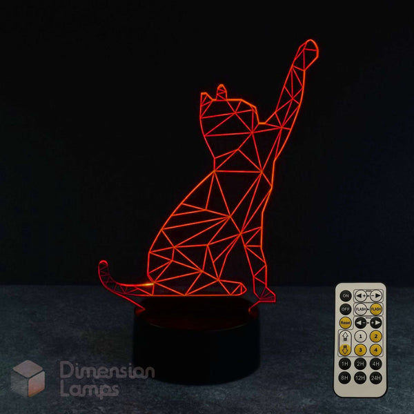 A red illuminated 3D cat silhouette night light on a black base, shown with a remote control against a dark background. A 'Dimension Lamps' logo watermark is visible in the lower-left corner.