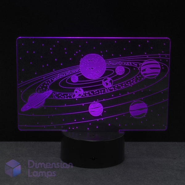 An LED night light of a purple solar system design, featuring planets and stars etched onto a clear acrylic panel, perfect kids astronomy gift idea.