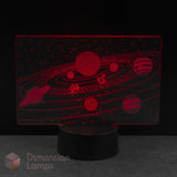 A Dimension Lamps LED night light featuring a red laser-cut solar system design on a clear acrylic panel. Young astronomers space themed gift idea. 