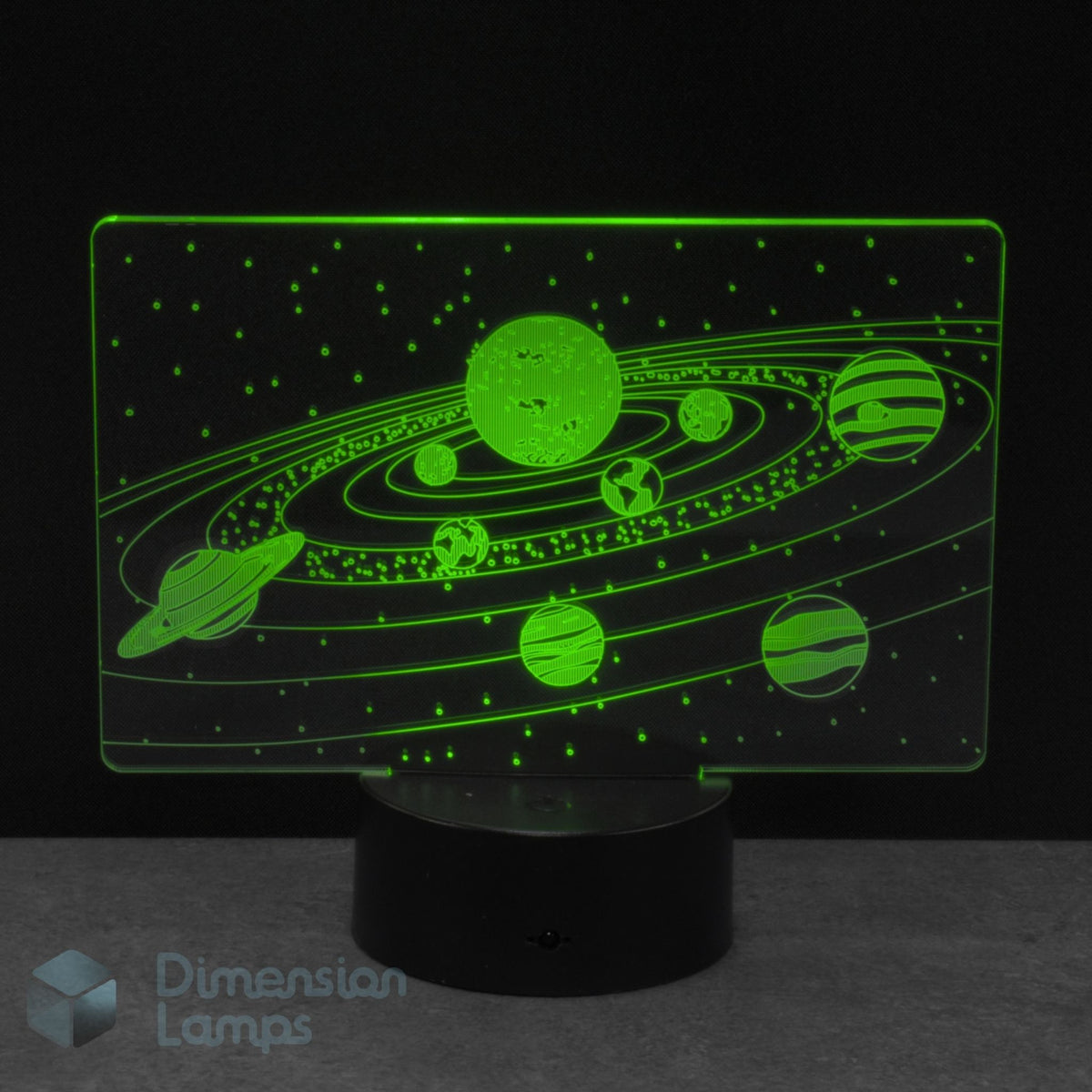 A 3D acrylic night light of a glowing green solar system design with planets and stars against a dark background, with a 'Dimension Lamps' watermark.