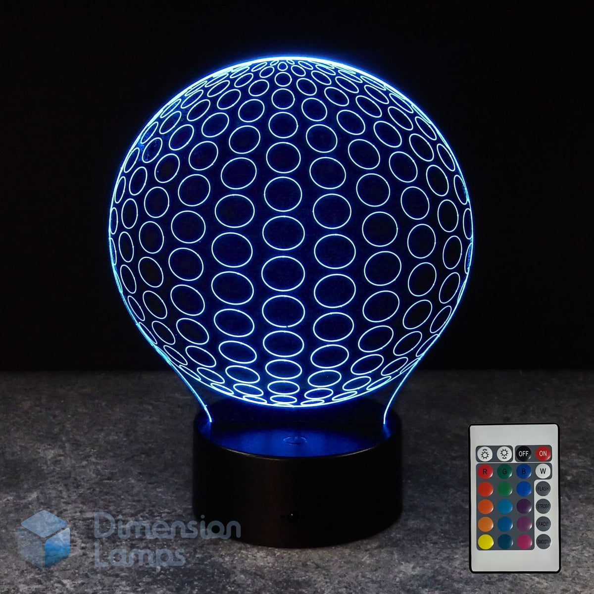 A 3D optical illusion LED lamp shaped like a spherical ball, glowing with blue light, shown on a dark base with a 16 colour remote control in the bottom right corner.