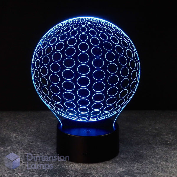 A 3D optical illusion LED lamp shaped like a sphere, glowing with a blue circular pattern on a black base against a dark background.