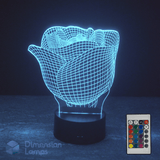 Wireframe Rose head 3D LED lamp with a remote control on a dark background