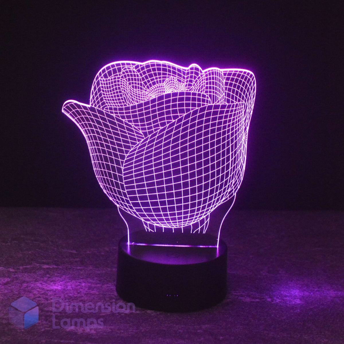 A 3D optical illusion LED night light shaped like a rose, glowing with a purple wireframe pattern on a black cylindrical base against a dark background.