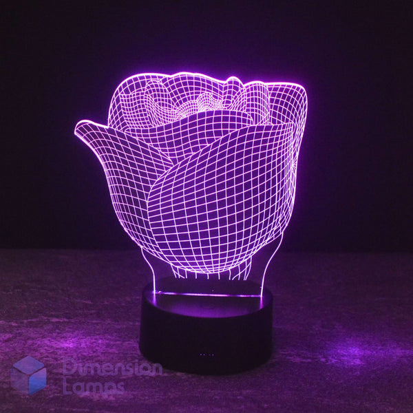 A 3D optical illusion LED night light shaped like a rose, glowing with a purple wireframe pattern on a black cylindrical base against a dark background.