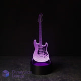 A 3D laser-cut electric guitar LED night light glowing with purple light, standing on a black circular base against a dark background. Guitarist gift idea. 