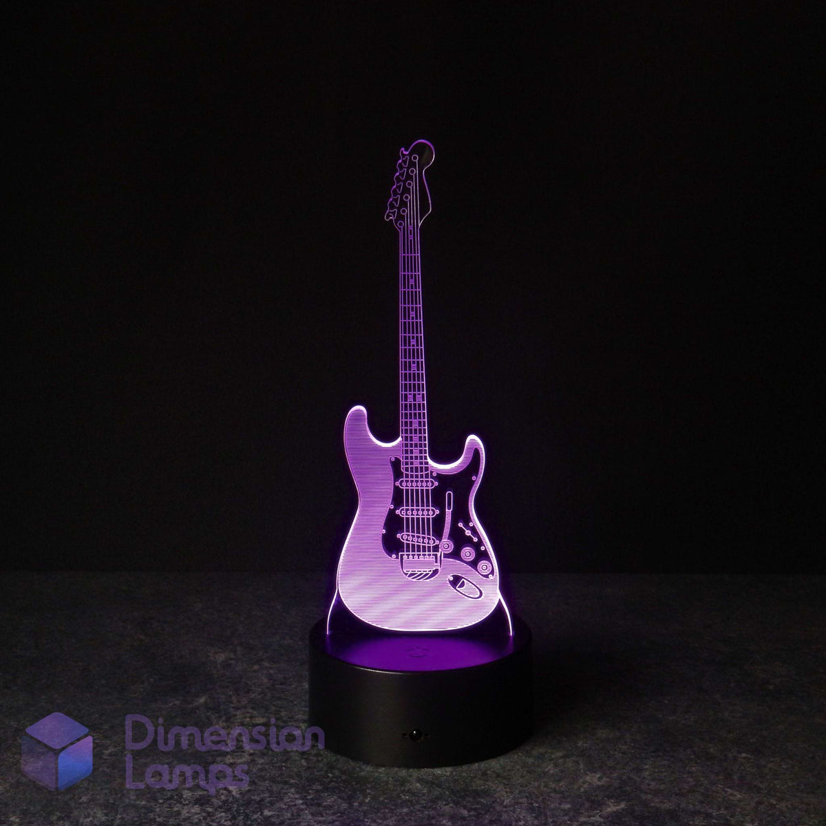 A 3D laser-cut electric guitar LED night light glowing with purple light, standing on a black circular base against a dark background. Guitarist gift idea. 