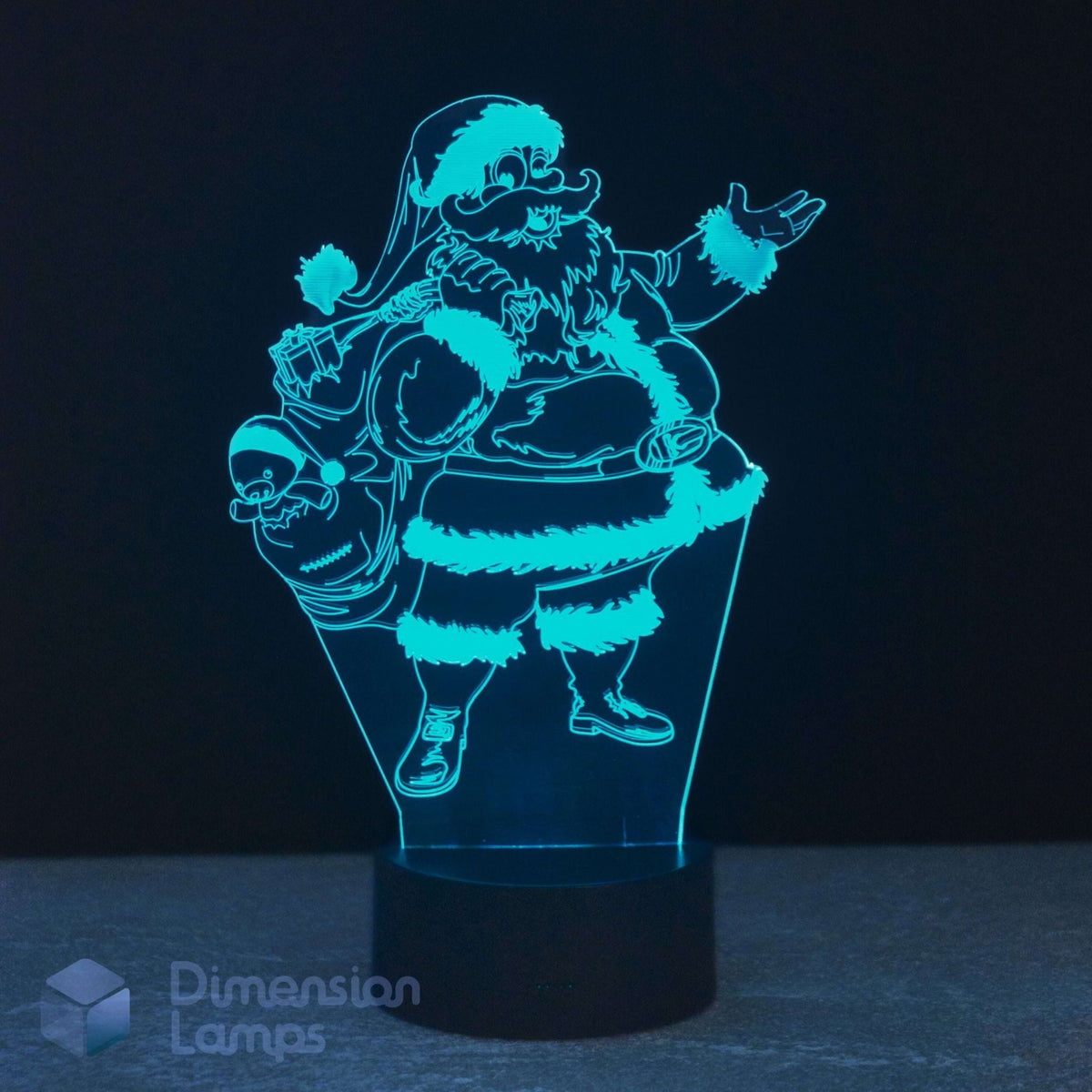 A 3D optical illusion LED night light depicting Santa Claus carrying a sack of gifts, glowing with a bright cyan-blue light on a black base against a dark background.