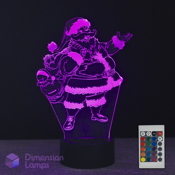3D LED lamp with Santa Claus design and remote control on a dark background