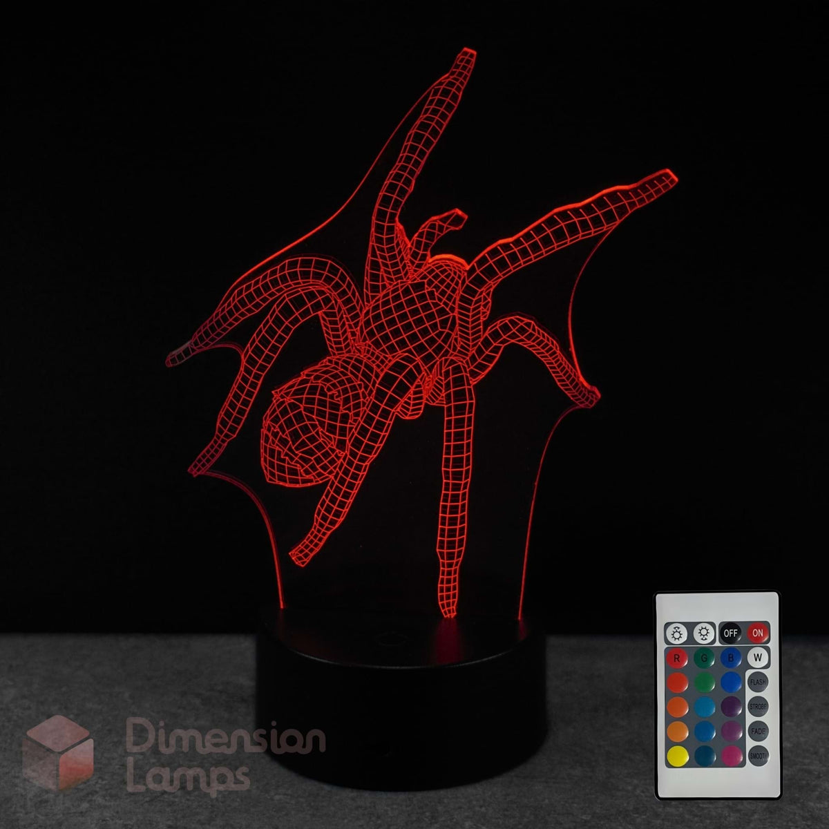 A red LED spider-shaped 3D optical illusion night light on a black base, shown with a 16 colour remote control against a black background. The brand name 'Dimension Lamps' is visible as a watermark in the bottom-left corner.