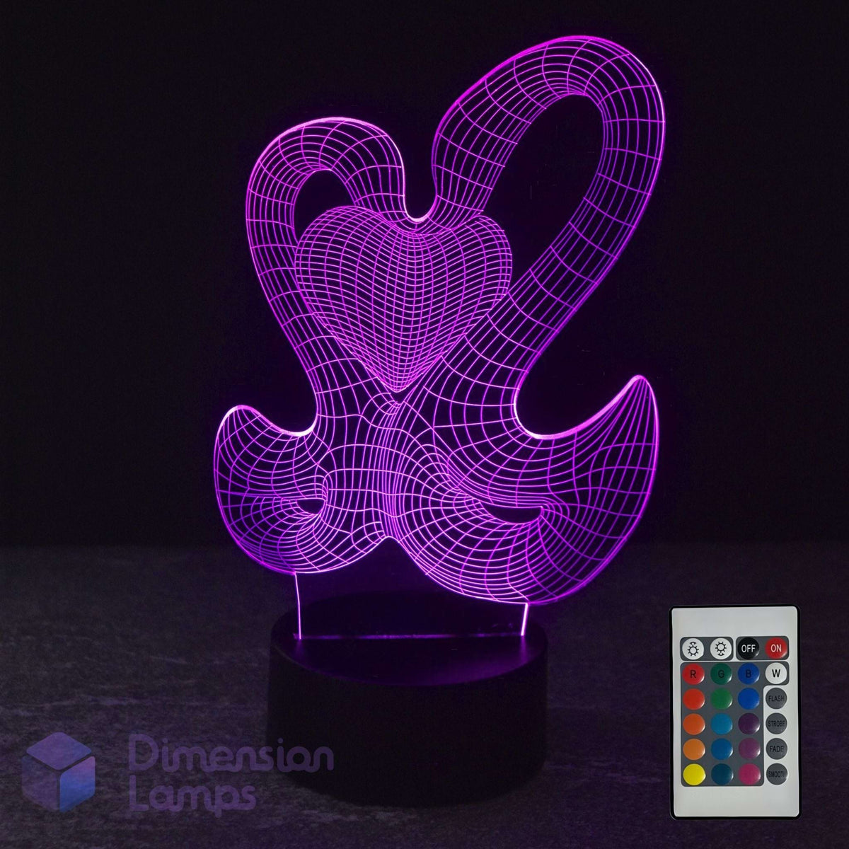A 3D optical illusion LED night light with two interlocking hearts, glowing purple on a black base, with its 16-colour remote Dimension Lamps logo.