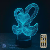 A 3D optical illusion night light two interlocking hearts in glowing cyan wireframe on a black base. 7-colour remote control by Dimension Lamps.
