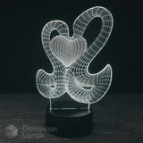 A 3D optical illusion LED night light by Dimension Lamps, featuring 2 swans glowing white forming a wireframe heart against a dark background.