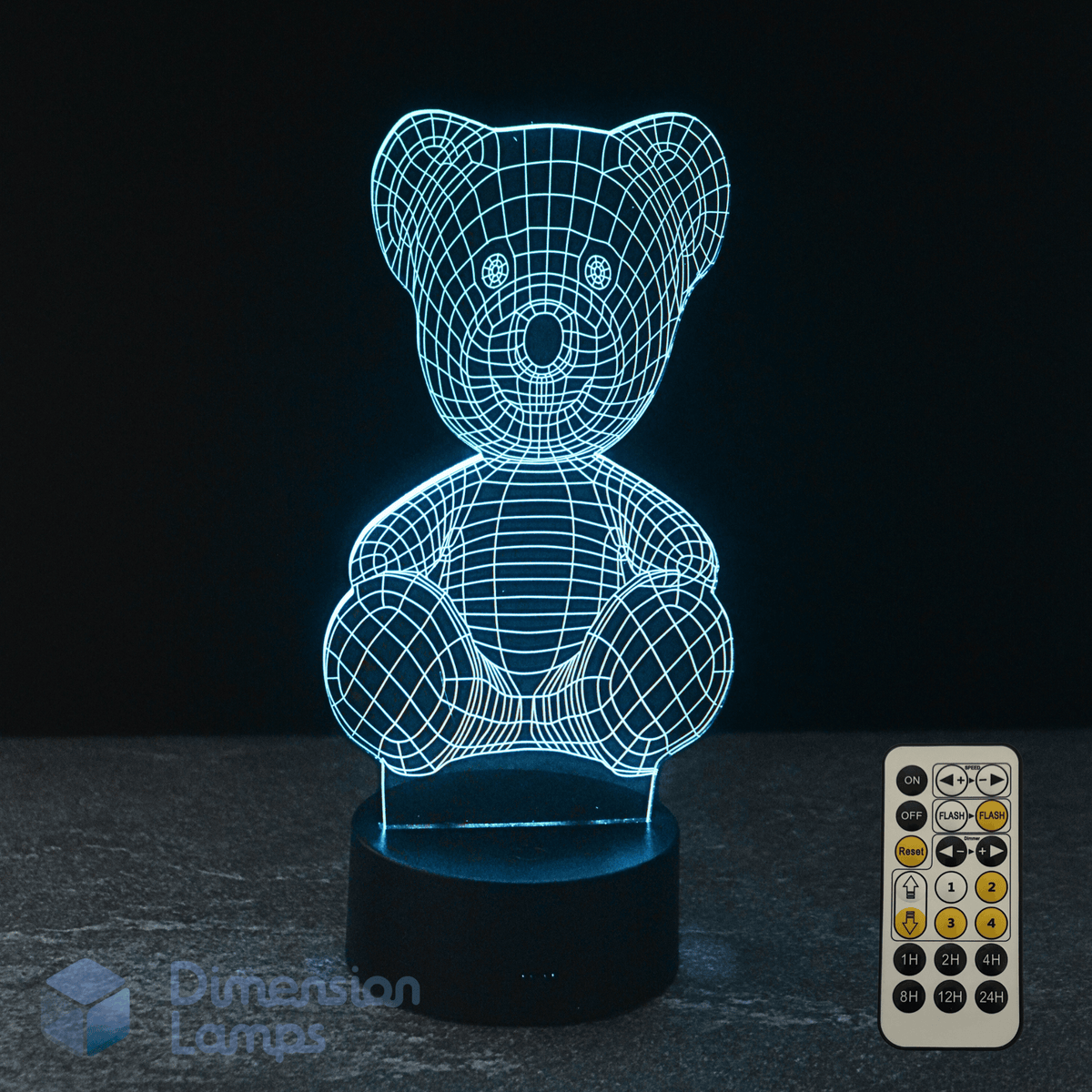 3D wireframe kids night light teddy bear lamp with remote control on a dark surface.
