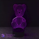 A purple illuminated Teddy Bear 3D LED lamp on a dark background, depicting a seated teddy bear figure.