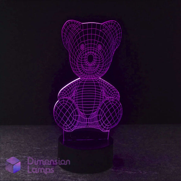 A purple illuminated Teddy Bear 3D LED lamp on a dark background, depicting a seated teddy bear figure.