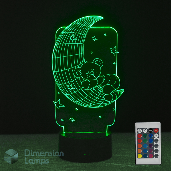 3D LED lamp with a bear on a moon design and remote control on a dark background