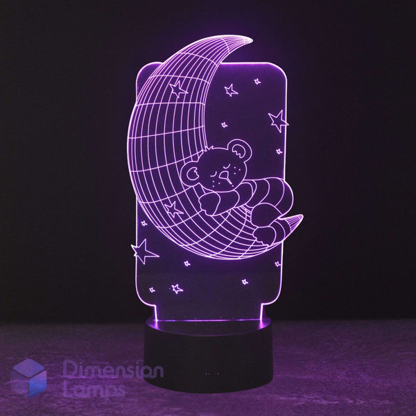 A 3D LED night light featuring a teddy bear sleeping on a crescent moon with stars, glowing purple on a black base. Calming night light for kids. 