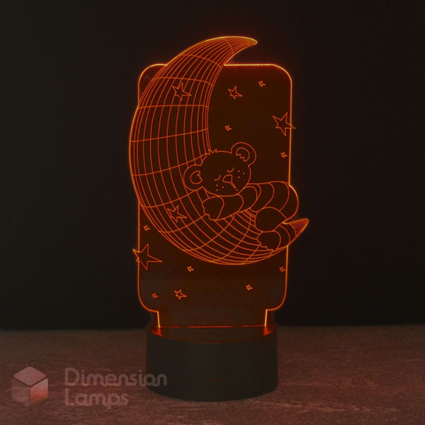 A 3D LED night light featuring a teddy bear sleeping on a crescent moon, glowing with a warm red light against a dark background. Calming night light. 