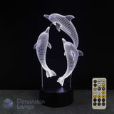 3D LED lamp with dolphins design and remote control on a black background