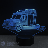 Cyan illuminated 3D truck-shaped lamp with a black background. Freighter themed kids lamp.