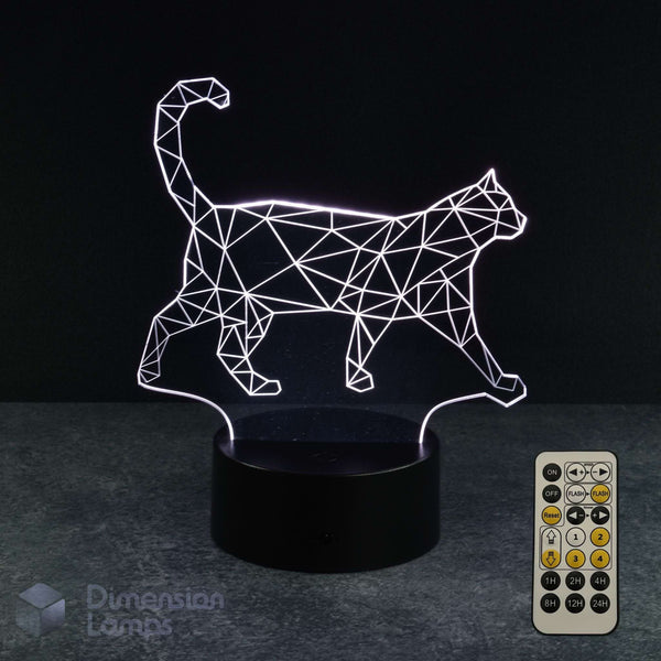 A 3D optical illusion lamp shaped like a walking cat, emitting a white geometric line pattern, resting on a black cylindrical base with a 7 colour sleep timer remote control shown on the right. The background is a dark studio setting.