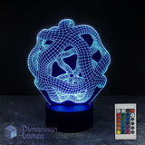 A 3D optical illusion lamp with a cyan wireframe warped space design on a black base, shown alongside its 16 colour remote control against a dark background.