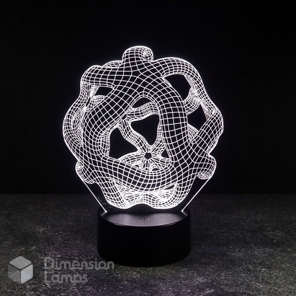 A 3D optical illusion LED night light with an intricate, glowing white wireframe knot design on a black cylindrical base, set against a dark background.