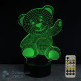 Green teddy bear-shaped lamp with remote control on a dark background. Baby shower gift idea.